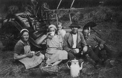 Frühstück bei der Ernte bei Bauer Paul Lohmann, links und rechts Zwangsverpflichtete polnische Landarbeiter, 1940. Es war den Bauern bei Strafe verboten, mit den Polen gemeinsam zu essen. 