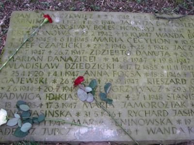 Cross and memorial slabs at the graveyard in Petershagen-Frille -  