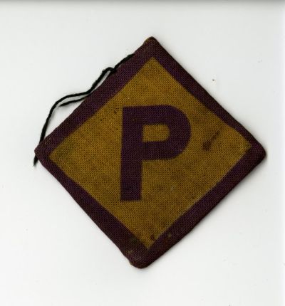 Badge ‘P’	 - Donated by Wiktor Opiński, who was forced to wear this badge as a forced labourer during the Second World War. Presented to Porta Polonica in 2013 by Father Dr Ryszard Mroziuk of the Polish Catholic Mission in Dortmund 